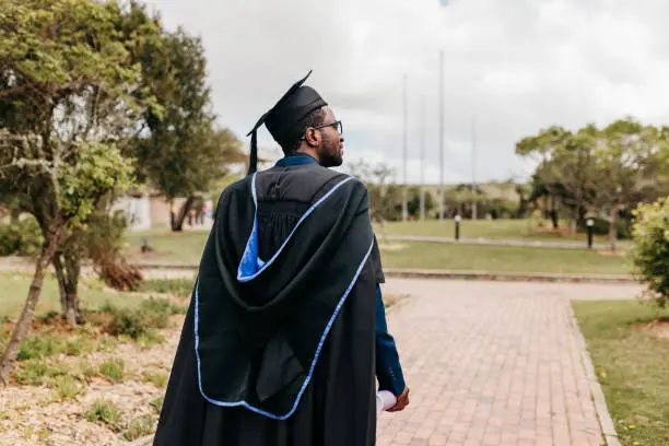 Male graduate walking down a campus | 10 Best Universities in Africa