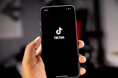 a person holding a black phone on tiktok || TikTok's STEM feed in Africa.